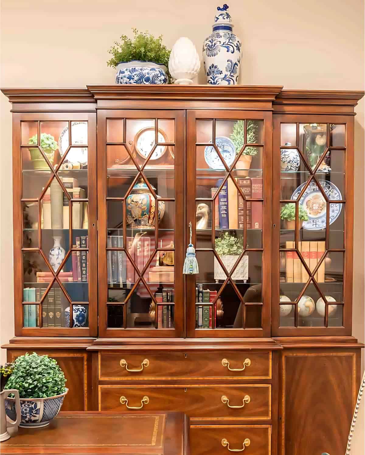 traditional china buffet filled with office books and decor