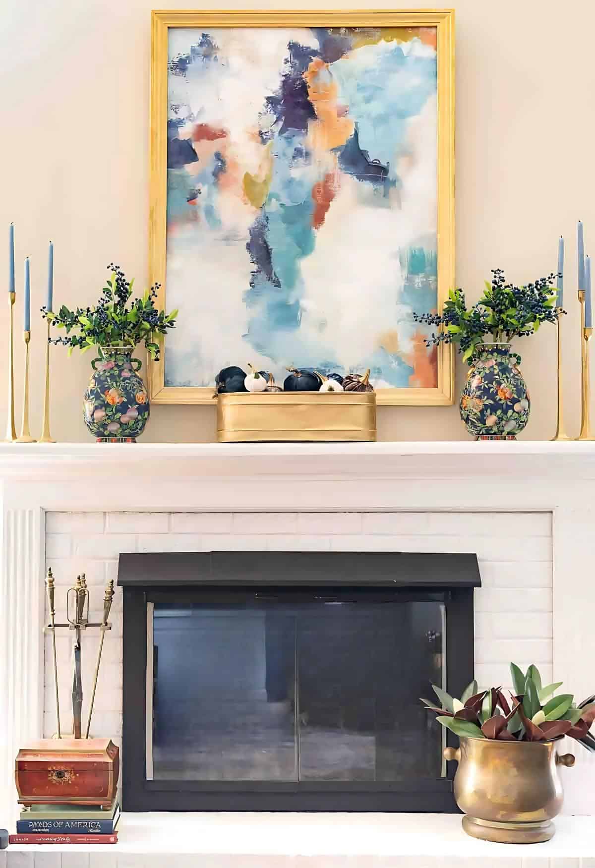 white brick fireplace hearth and mantel decorated for fall