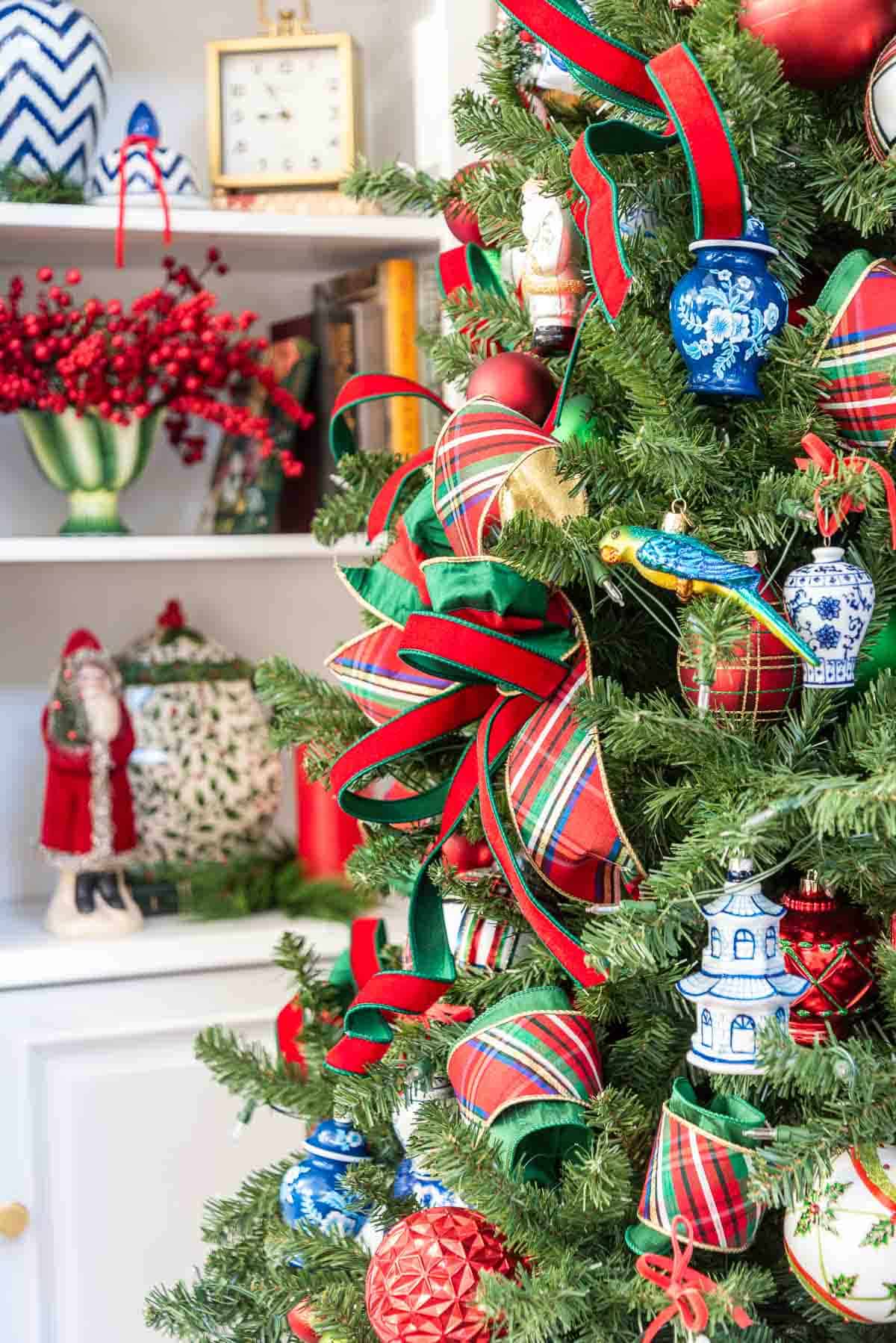 partial view of a Christmas tree with traditional red and green decorations