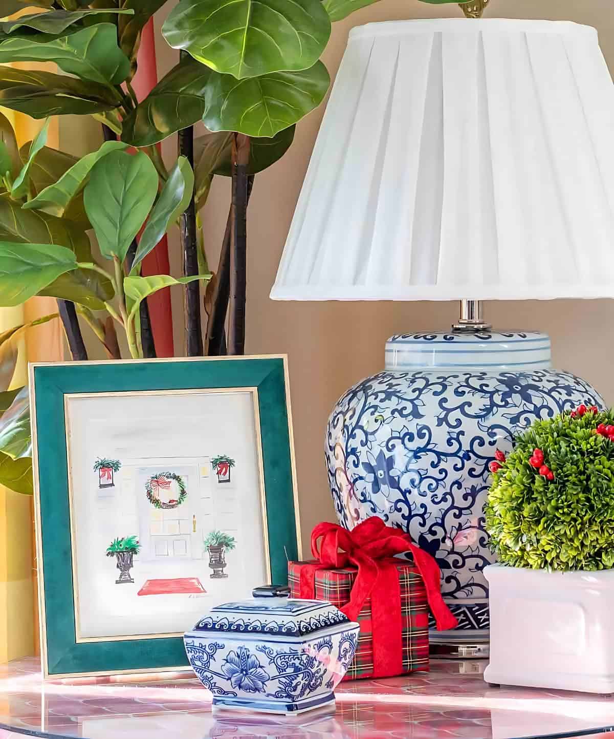 blue and white lamp on a table with other Christmas accessories