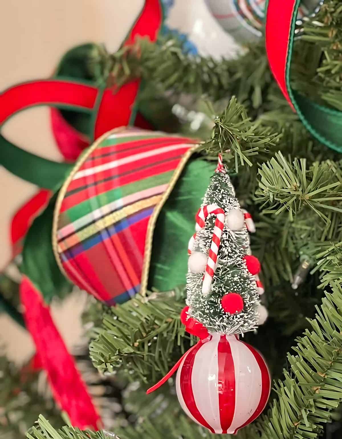 Chinoiserie Christmas tree decorated with red and green ornaments and blue and white Chinoiserie ornaments and tartan plaid ribbon