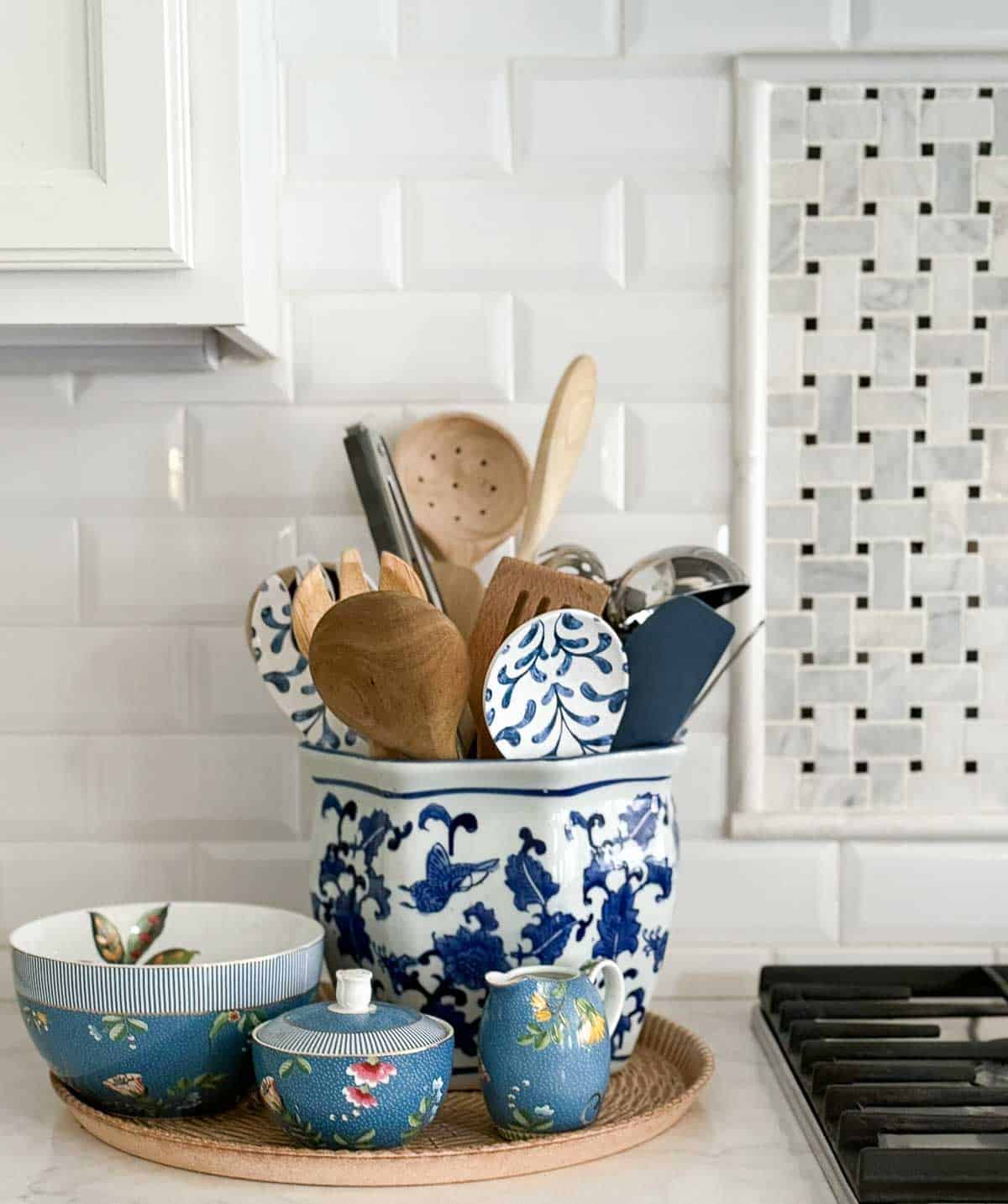 blue, white, and green accessories in an all white kitchen