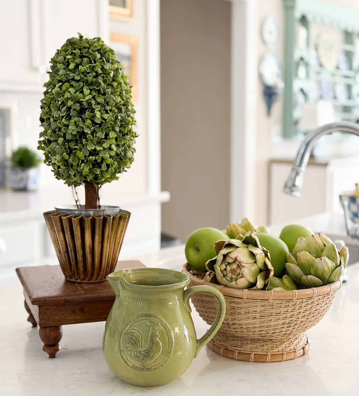 green and wood accessories in an all white kitchen