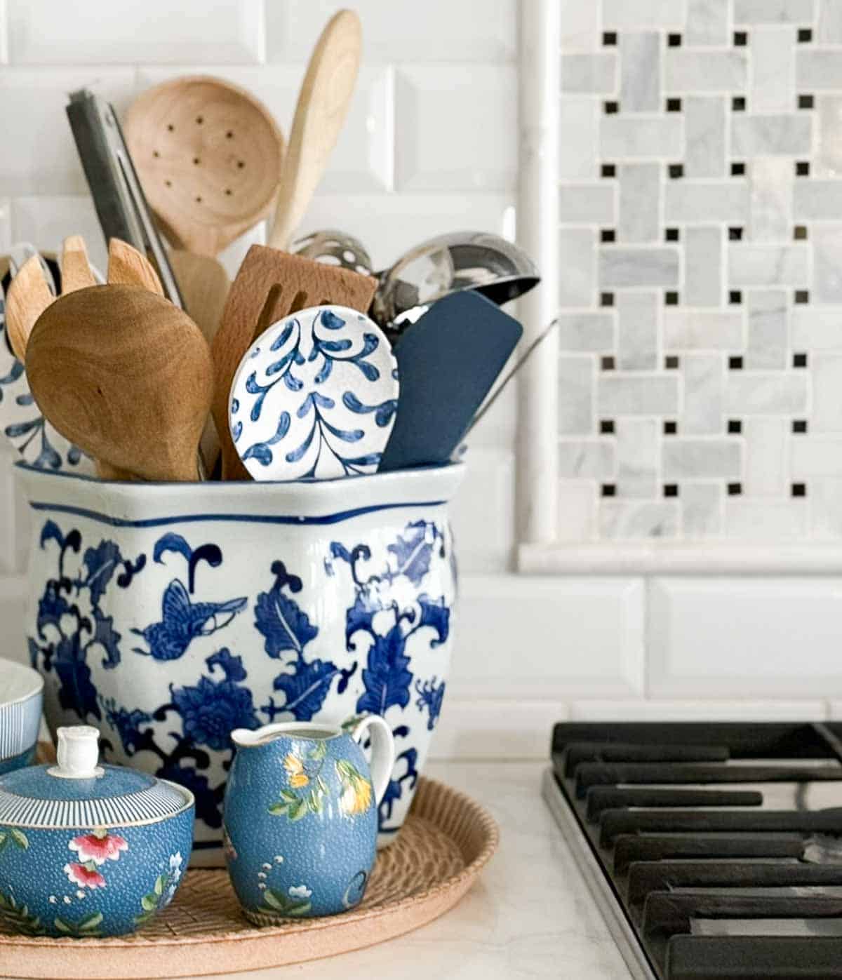 blue, white, and green accessories in an all white kitchen